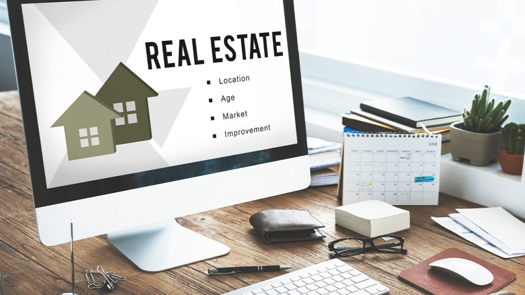 Office table with computer monitor showing real estate mortgage loan concept.