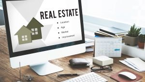 Office table with computer monitor showing real estate mortgage loan concept.